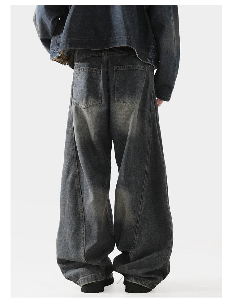 Baggy scimitar-style dark blue black vintage coloured washed jeans