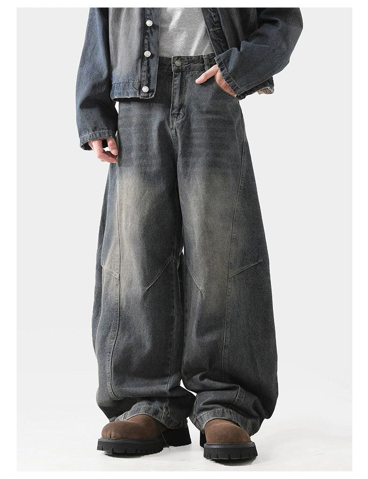 Baggy scimitar-style dark blue black vintage coloured washed jeans