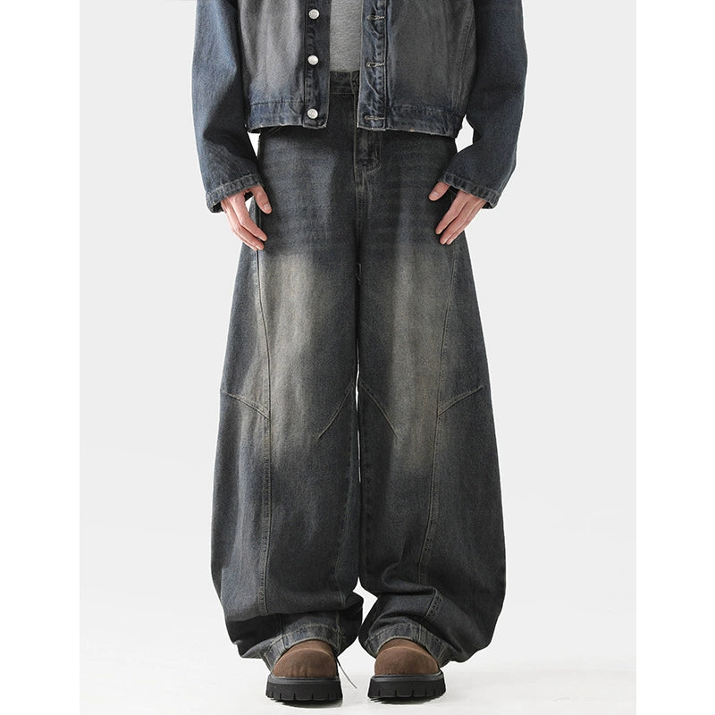 Baggy scimitar-style dark blue black vintage coloured washed jeans