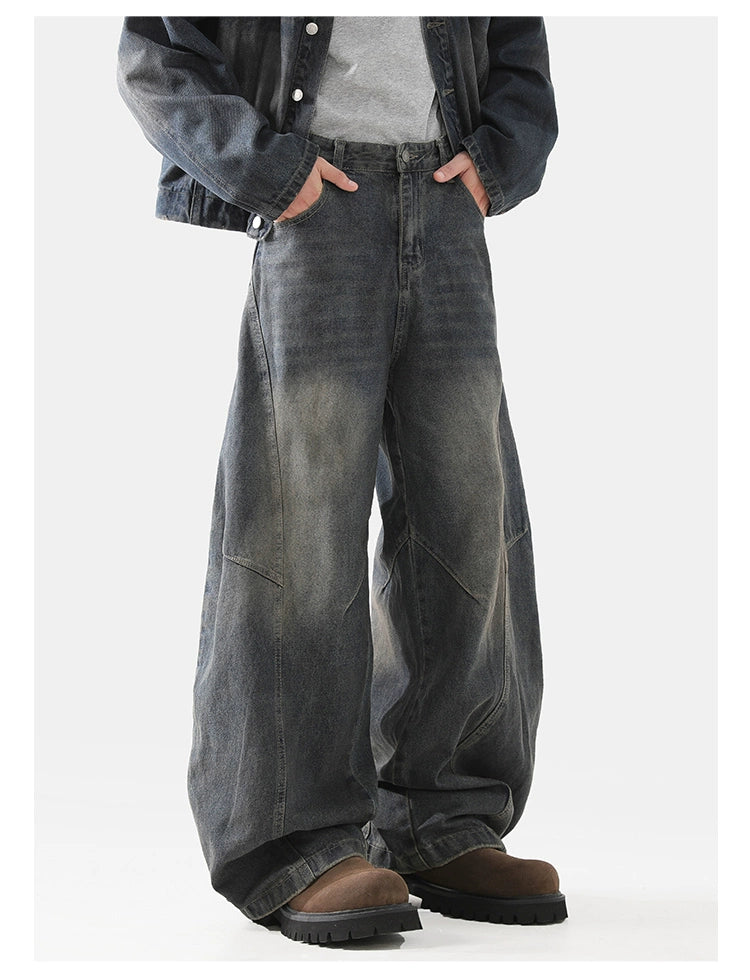 Baggy scimitar-style dark blue black vintage coloured washed jeans
